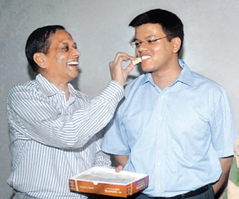 AK Mohanty offering sweets to his son Abhishek in Hyderabad on Wednesday.