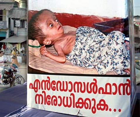 File- The billboard showcasing a victim of Endosulfan placed at the Old Bus Stand in Kannur