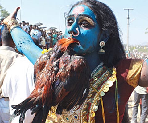 SAVAGE INSTINCTS: A woman priest performs a ritual in a cemetery during the Mayana Kollai festival in Vellore. (EPS)