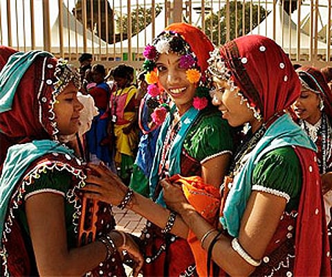 Folk performers in traditional dress queue outside New Delhi’s Jawaharlal Nehru Stadium, the main venue of the Commonwealth Games. AP