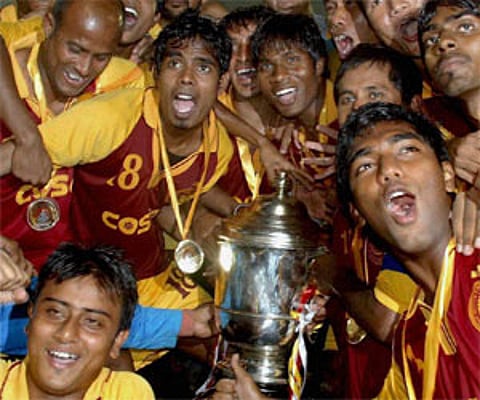 Players of West Bengal football team jubilate after winning the 65th Santosh Trophy at Nehru Stadium in Guwahati on Monday. PTI