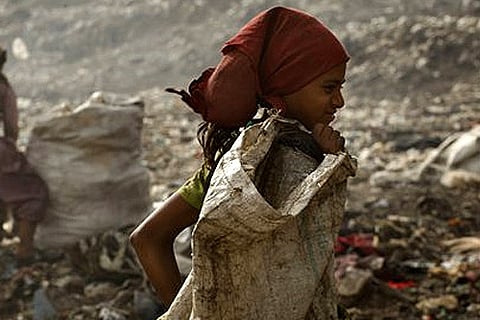 Girls scavenge for plastic and otheritems that can be sold to scrap dealers, at a garbage dump on the outskirts of New Delhi.