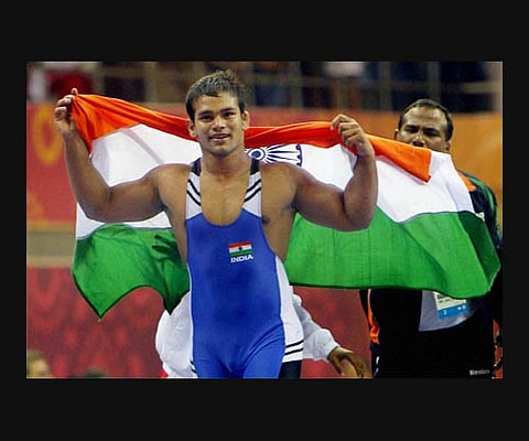 India's Narsingh Yadav celebrates after defeating Richard Bri Adinall of South Africa to win gold in the 74kg freestyle category. AP