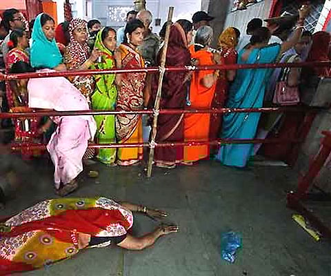 A Hindu devotee prostrates as others stand in a queue inside the Alopi Devi temple on the first day of Navaratri, or nine nights festival, in Allahabad. AP Photo