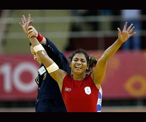 India's Alka Tomar reacts as she is declared winner in the women's 59kg wrestling event. AP