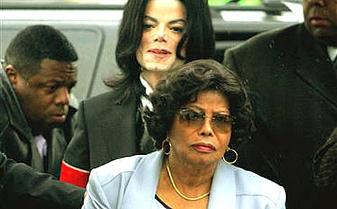 Michael Jackson follows his mother, Katherine Jackson, as they arrive for court on the opening day of his child molestation trial at Santa Barbara County Superior Court in Santa Maria, Calif. (AP Photo/Marcio Jose Sanchez, File)
