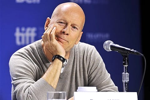 Bruce Willis smiles during the press conference for his new movie "Looper" during the 2012 Toronto International Film Festival in Toronto (AP Photo/The Canadian Press, Aaron Vincent Elkaim)