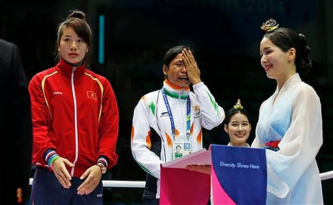 India's Sarita Devi cries standing beside bronze medalist Vietnam's Thi Duyen Luu after she refused her bronze medal during the medal ceremony for the women’s light 60-kilogram division boxing at the 17th Asian Games in Incheon, South Korea, Wednesday |