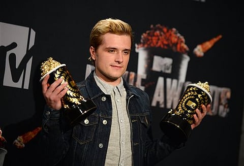 Josh Hutcherson poses with his best male performance award and movie of the year award for "The Hunger Games: Catching Fire" in the press room at the MTV Movie Awards at Nokia Theatre in Los Angeles. | Photo by Jordan Strauss/Invision/AP