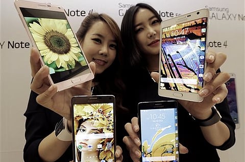 In this file photo, Models display Samcung smartphones in an expo. (AP File Photo)