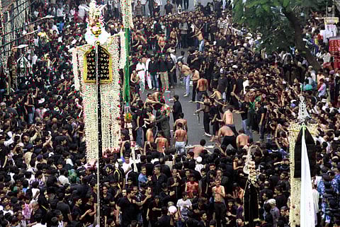 Muslim man flagellates himself with knives tied to a chain during Muharram procession in Mumbai