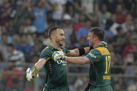 South Africa’s Faf du Plessis, left, celebrates his hundred runs captain A.B. de Villiers during the final one-day international cricket match of a five-game series against India in Mumbai, India. |AP