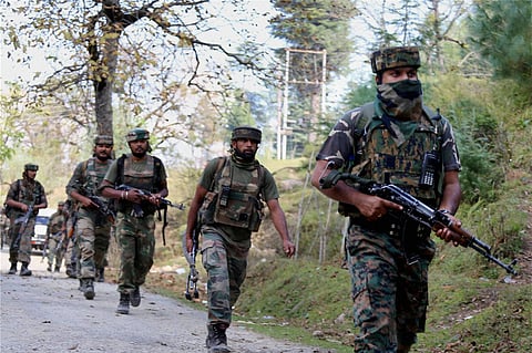 Army personnel march towards the site where militants hiding during the ongoing encounter in which four army jawans and one militants killed at Hafruda forest area of Handwara in north Kashmir on October 5. | PTI