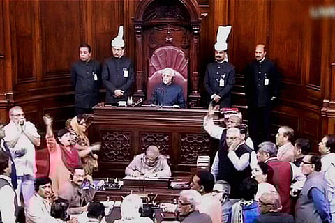 Members protesting in the well of the Rajya Sabha in New Delhi.