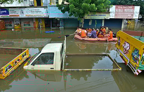People being ferried out of the partially flooded Jafferkhanpet, near Kasi Theater on December 3. (A Raja Chidambaram | EPS)