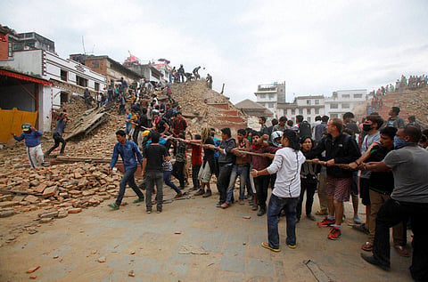 Volunteers help remove debris of a building that collapsed at Durbar Square after an earthquake in Kathmandu Nepal Saturday April 25 2015. (PTI)