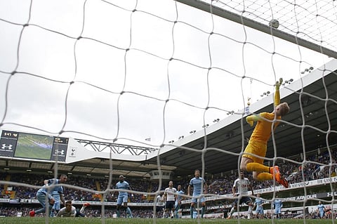 Manchester City's English goalkeeper Joe Hart (R) jumps to tip the ball over the crossbar during the English Premier. |AFP
