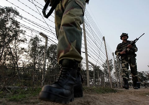 Indian Border Security Force (BSF) soldiers patrol along the border fence on the India-Pakistan border at Suchet Garh in Ranbir Singh Pura, about 36 kms from Jammu. (AFP)