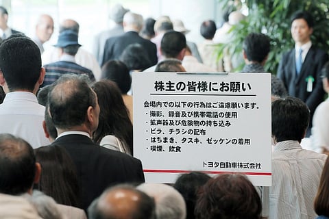 Shareholders enter the headquarters of Japanese auto giant Toyota Motor to attend the shareholders meeting in Toyota city in Aichi prefecture, central Japan. |AFP