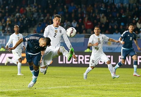 Argentina's Sergio Aguero, left, heads the ball to ecore the opening goal during a Copa America Group B soccer against Uruguay match at La Portada stadium in La Serena, Chile. |AP