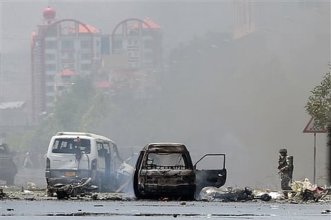 An Afghan National Army soldier stands at the site of a suicide attack during clashes with Taliban fighters in front of the Parliament, in Kabul, Afghanistan. |AP