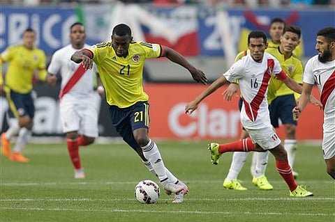 Colombia's Jackson Martinez runs with the ball during a Copa America Group C soccer match at against Peru the Bicentenario German Becker stadium in Temuco, Chile. |AP