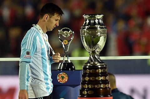Argentina's forward Lionel Messi walks with the second place medal of the 2015 Copa America football championship, in Santiago, Chile. |AFP