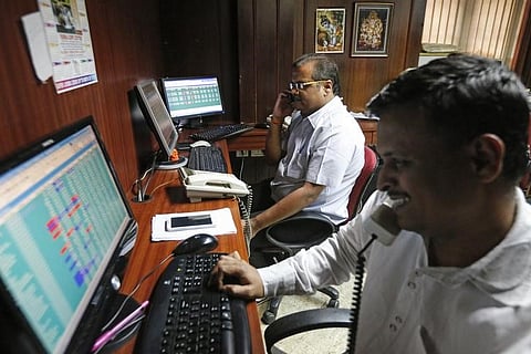 Brokers trade at their computer terminals at a stock brokerage firm in Mumbai. |Reuters