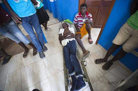 An injured man lies in a litter at a police station in Marfranc, Haiti. The police station is serving as a makeshift clinic, for cholera patients and those injured by Hurricane Matthew. |AP