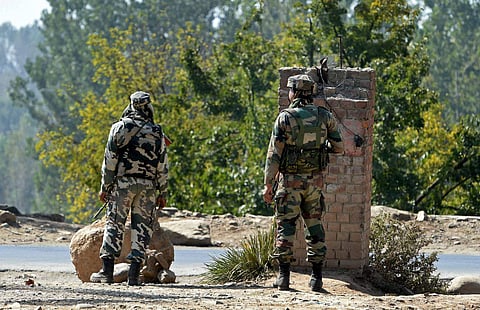 Army personnel maintaining a vigil outside a government building where some militants are holed up at Pampore 16 kms from Srinagar on Monday. | PTI