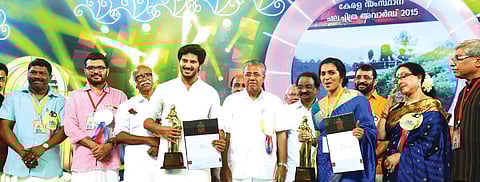 Chief Minister Pinarayi Vijayan posing with the award winners, including best actors Dulquer Salman and Parvathy, at the Kerala state awards function in Palakkad on Saturday