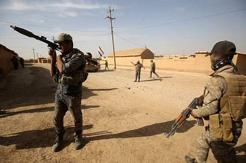 Iraqi forces deploy in the Bajwaniyah village, about 30 kms south of Mosul, on October 18, 2016 after they liberated it from Islamic State (IS) group jihadists. | AFP