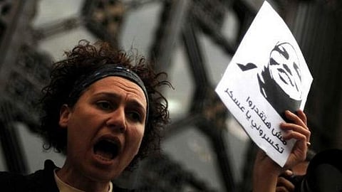 An Egyptian women shouts political slogans during a demonstration in Cairo on March 16, 2012, in solidarity with Samira Ibrahim (portrait), an Egyptian woman who brought the case against a doctor|AFP