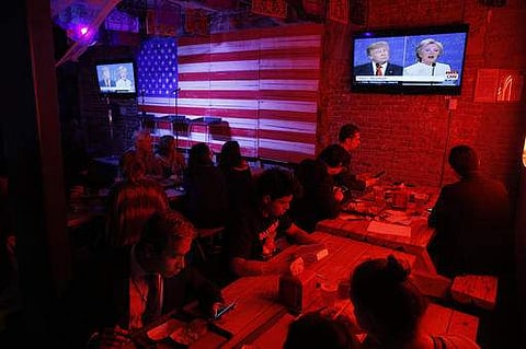 Customers watch the third and last U.S. presidential debate at the Pinche Gringo BBQ restaurant in Mexico City. | AP