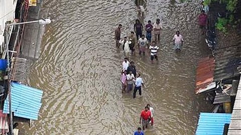 People wait for food packets in floodwaters following heavy rains that hit Chennai in 2015 | AP