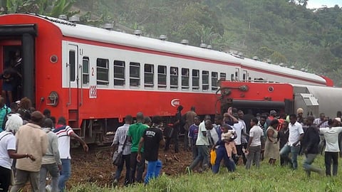 In this image made from video, people walk beside a derailed train carriage after an accident in Eseka, Cameroon, Friday, Oct. 21, 2016. | AP