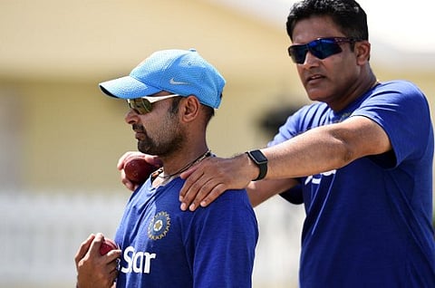 Indian cricket team head coach Anil Kumble (R) chats with bowler Amit Mishra during a practice session at the Warner Park stadium in Basseterre, Saint Kitts, on July 13, 2016. | AFP