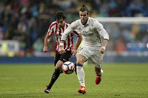 Real Madrid's Gareth Bale duels for the ball with Athletic Bilbao's Mikel San Jose at the Santiago Bernabeu. (Photo | AP)