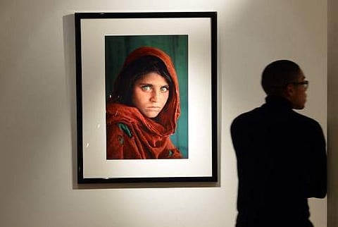 'Afghan Girl, 1984' by photographer Steve McCurry (estimate- USD $30,000 to $50,000) on display as part of 'The National Geographic Collection