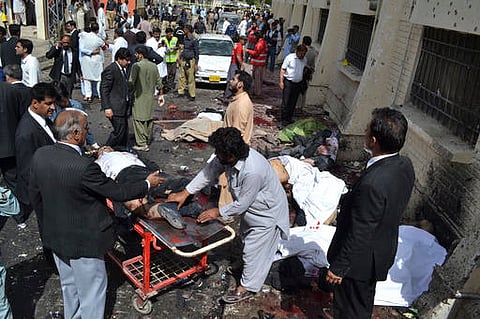 People help victims of a bomb blast in Quetta, Pakistan.