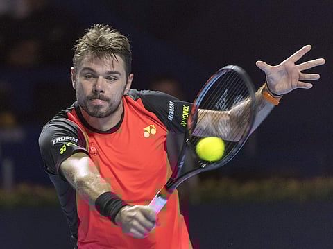 Switzerland's Stan Wawrinka returns a ball to Donald Young of the US during the Swiss Indoor tennis tournament at the St. Jakobshalle in Basel. | AP