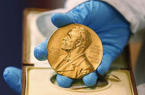 In this file photo, a national library employee shows the gold Nobel Prize medal awarded to the late novelist Gabriel Garcia Marquez, in Bogota, Colombia.