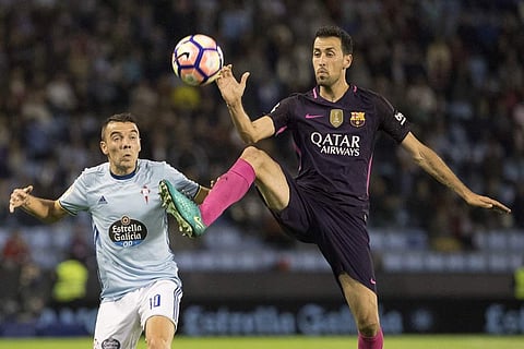 Barcelona's Sergio Busquets, right, challenges for the ball with Celta's Iago Aspas. (Photo | AP)