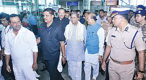 Chief Minister Siddaramaiah at the Mangalore International Airport. Ministers U T Khader and Ramanath Rai and MLAs K Abhayachandra Jain and Mohideen Bawa are also seen | Express