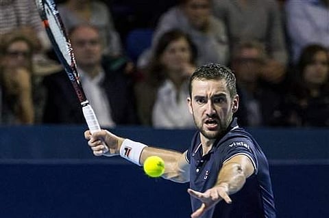 Croatia's Marin Cilic returns a ball to Japan's Kei Nishikori during their final match at the Swiss Indoors tennis tournament at the St. Jakobshalle in Basel. | AP
