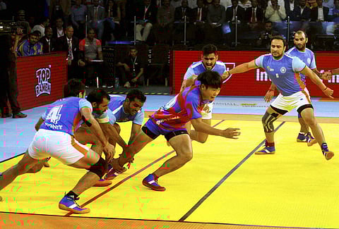 Indian players try to catch South Korean player Tae Beom Kim during their inaugural match of the Kabaddi World Cup-2016 in Ahmedabad. | PTI