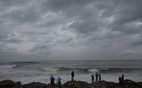 People stand on the coast watching the surf produced by Hurricane Matthew, on the outskirts of Jamaica on Oct. 3, 2016. The hurricane has hit parts of Jamaica, Haiti, Cuba and Bahamas. (Photo | AP)