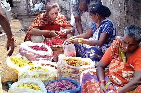 Vendors sorting out flowers near Poorna Market in Vizag on Saturday | Express