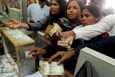 Indian passengers use 1000 and 500 rupee notes to purchase rail tickets at Allahabad Railway station. ( File photo | AFP)