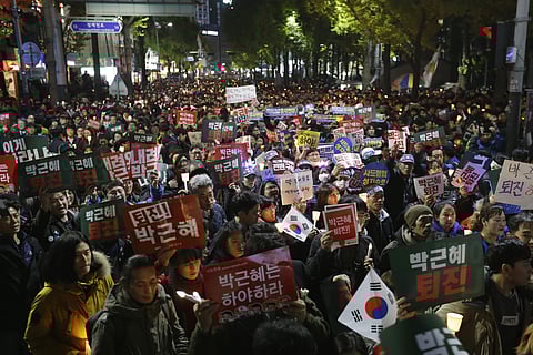 Protesters march toward presidential house after a rally calling for South Korean President Park Geun-hye to step down in Seoul, South Korea. | AP